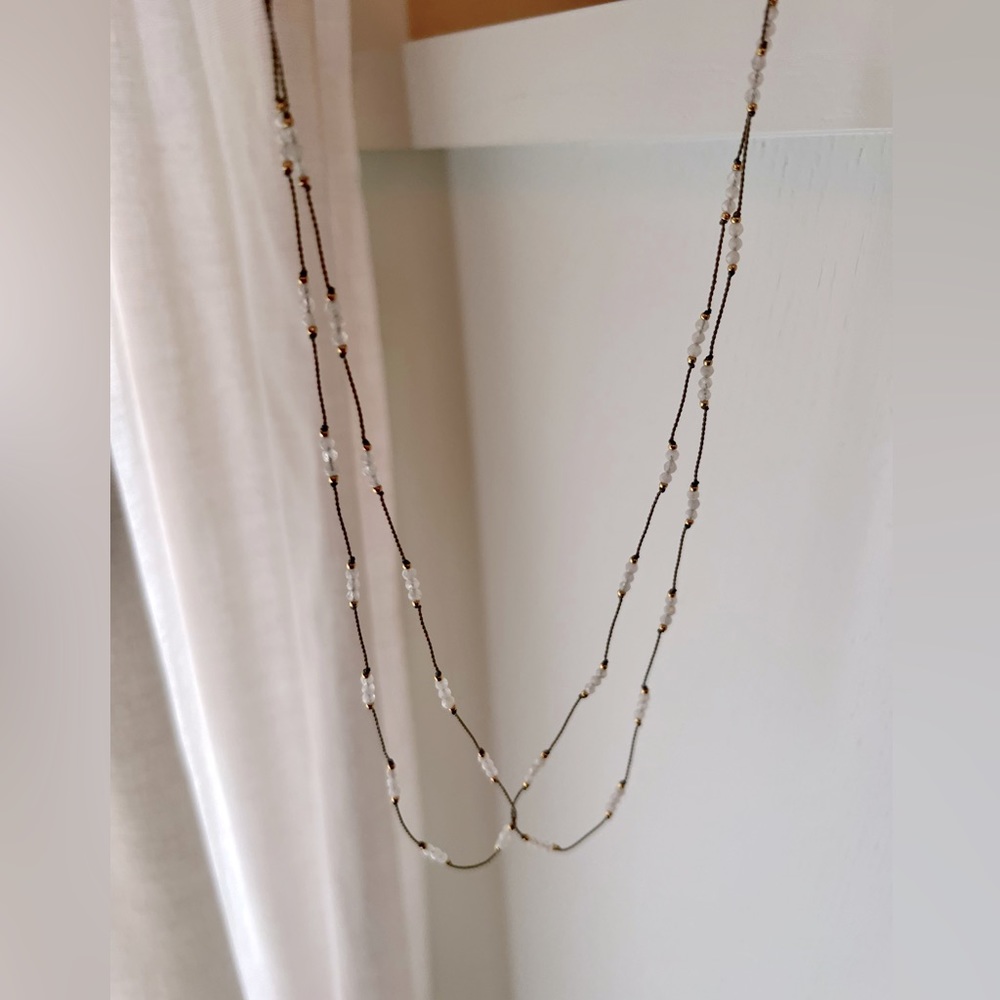 Thin beaded necklace with white stones